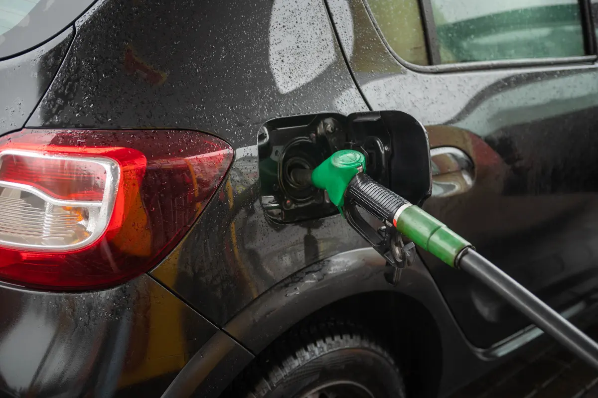 An Open Tank With A Fuel Hose At The Gas Station